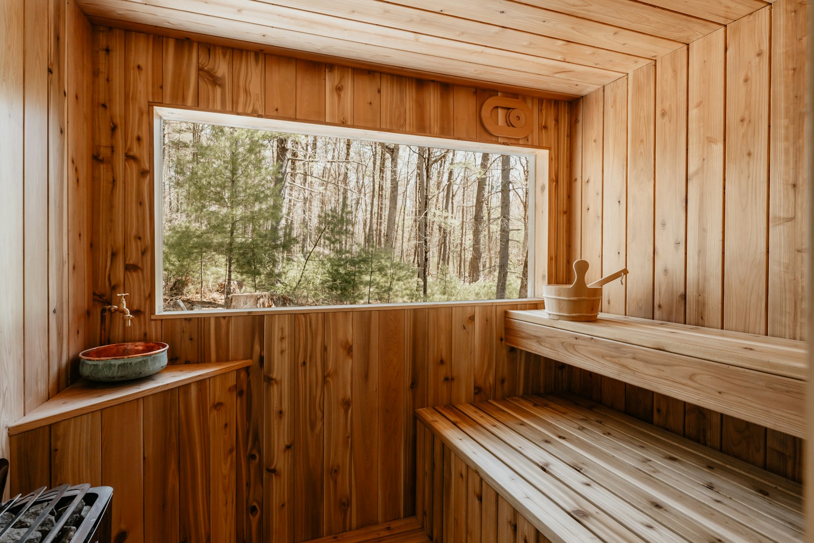 Wooden sauna overlooking forest — illustrative example